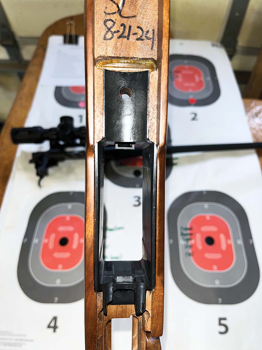 The recoil lug fit into a milled slot forward of the front anchoring bolt. This area was given a dab of bedding compound to tighten the fit. The polymer magazine well is adhered into the stock and includes thicker material fore and aft.